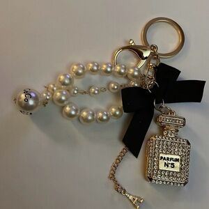 Elegant Pearl and Gold Keychain with Black Bow